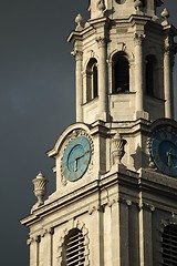 Image showing Clock tower against dark sky with clock in the middle before sto