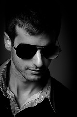 Image showing Closeup of a young man wearing sunglasses in black and white