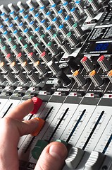 Image showing Closeup of an audio sound mixer with the hand of a man