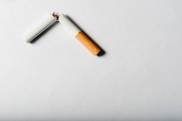 Image showing Broken cigarette on white background with harsh shadows