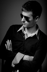 Image showing Portrait of a young man wearing sunglasses in black and white