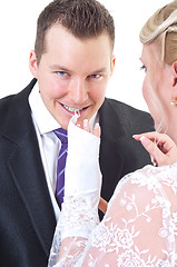 Image showing Groom undressing bride while taking off her gloves