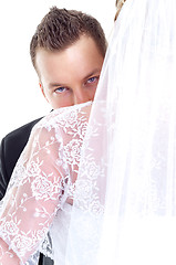 Image showing Groom looking over her wife's shoulder