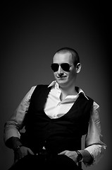 Image showing Portrait of a young man wearing sunglasses in black and white