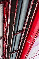 Image showing angle shot of pipes going between metal plates