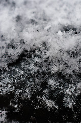 Image showing Ice cristals falling with black background macro shot