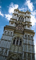 Image showing Clock tower against blue sky with clock in the middle