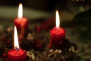 Image showing Christmas candles on girlde with blurry background