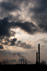 Image showing silouette of a powerplant with smoke coming out of chinney