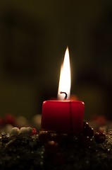 Image showing Christmas candle on girlde with blurry background