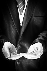 Image showing Closeup of a man holding engagement rings