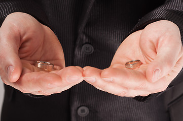 Image showing Mans palms holding wedding rings