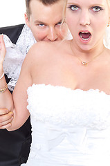 Image showing Groom bite's shoulder of the bride