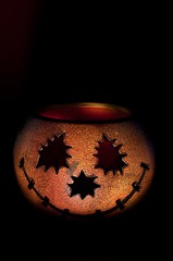 Image showing Pumkin shaped candle holder against dark background