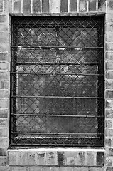 Image showing Old window closeup with bars on it  in black and white