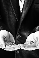 Image showing Man holding engagement rings in black and white