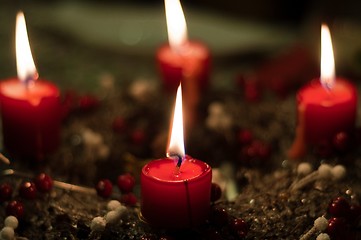 Image showing Christmas candles on girlde with blurry background