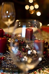 Image showing Candles and glasses with burry out of focus background