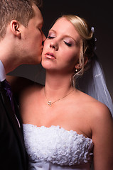 Image showing Groom kissing the bride