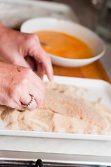 Image showing Fresh meat with crumb with the hands of the cook