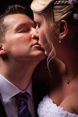 Image showing young couple in wedding wear kissing