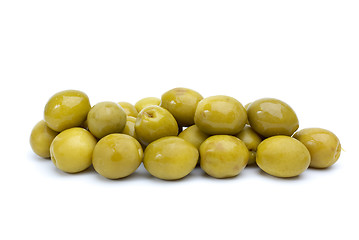 Image showing Some green olives with pits