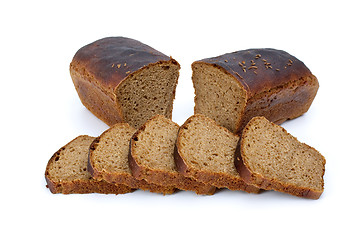 Image showing Two halves of rye bread with anise and some slices