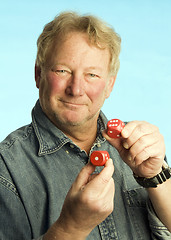 Image showing handsome middle age man holding dice