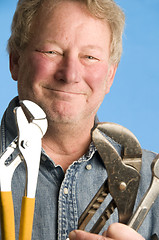 Image showing smiling happy contractor builder homeowner with tools