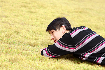 Image showing Young man lying on grass 