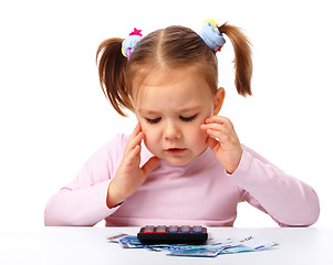 Image showing Little girl with few paper euro banknotes