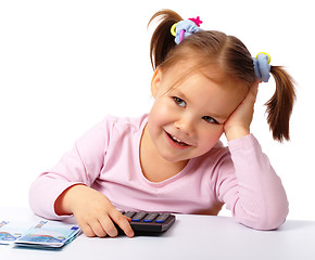 Image showing Little girl with few paper euro banknotes