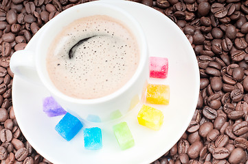 Image showing Multicolored slabs of shugar and cup of coffee