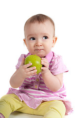 Image showing Baby girl in pink eating apple