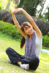Image showing woman doing stretching exercise in park