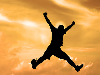 Image showing Jumping silhouette sunset sky-clipping path