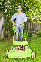 Image showing Man mowing lawn