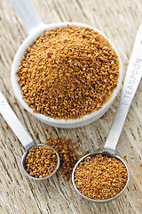 Image showing Coconut palm sugar in measuring spoons