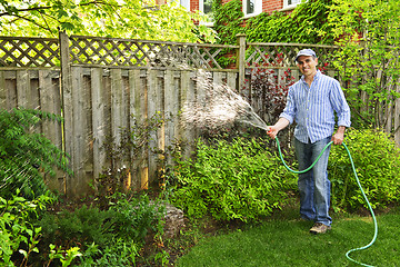 Image showing Man watering garden