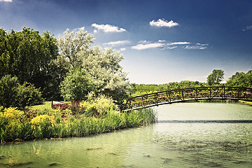 Image showing Pond with foot bridge