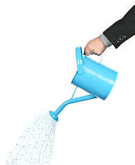 Image showing Hand pouring water from watering can