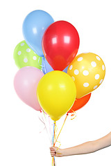 Image showing Hand holding balloons on white