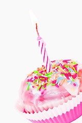 Image showing Single cupcake with pink lit candle