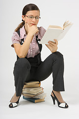 Image showing girl in glasses to book