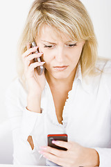 Image showing blonde with two mobile phones