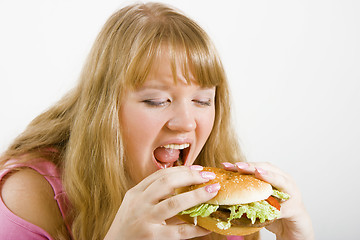 Image showing Hungry blonde and hamburger