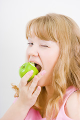 Image showing blonde bites the apple