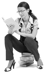 Image showing young girl with glasses reading a book