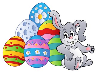 Image showing Bunny resting beside Easter eggs