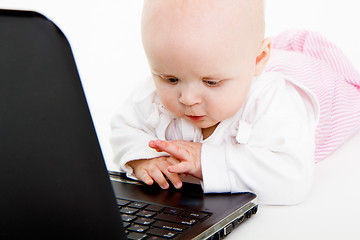 Image showing Baby playing with laptop